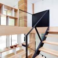 Architecture Easy Geometrical Arrangement Of Blonde Wooden Staircase With Shelves Attached To The Left Stylish-contemporary-duplex-with-cedar-cladding-and-black-framing-vitrine-back-side