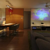 Interior Design The Media Room Near The Living Room With Sparkling Lighting On Desk Of Large Screen Charming-Spacious-Living-Room-with-Green-Rug-and-Grey-Couch