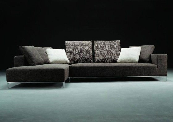 Minimalist Dark Grey Sofa With Floral And White Sofa Pads 560x394 Furniture